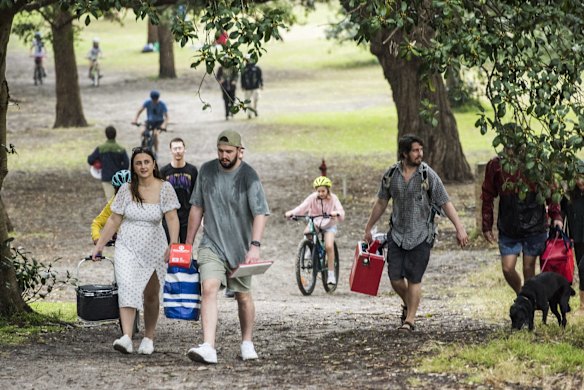 Picnics are packed up as the rain begins to fall at Centennial Park, as some restrictions ease.
