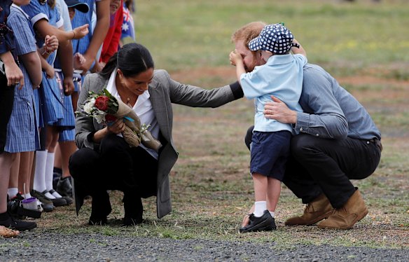 Prince Harry has his nose inspected by Luke Vincent, 5, on their arrival in Dubbo.