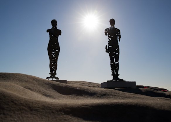 Egor Zigura's work, 'Kore that Awakening' and 'Colossus Awakening' at Sculpture by the Sea, in Sydney.