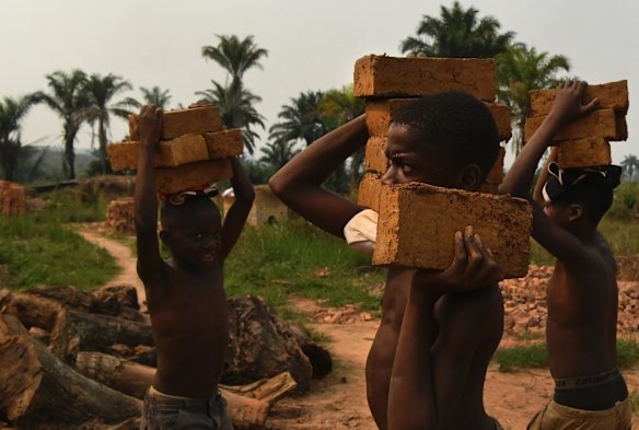 Children carrying bricks at the Kabukabuka brick factory. The children earn 2000 Congolese Francs a day for moulding bricks. The conflict in the Kasai has meant that many children cannot attend or afford to go to school.