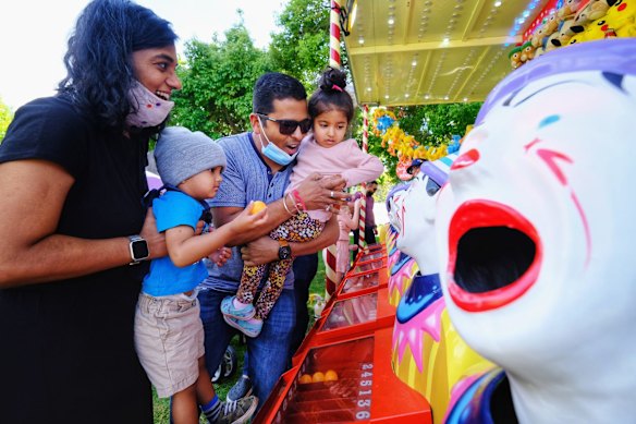 (R-L) Darshi Mehta with Aarav parab 2 and Harshit Doshi holding Vani Doshi 3 enjoy the games at Moomba.