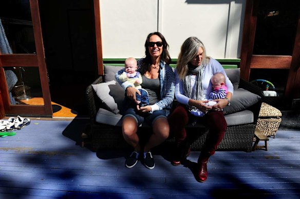 Canberra Capitals coach Carrie Graf, with partner Camille Chicheportische and baby twins Bentley (blue and yellow top) and Charli (blue and pink top).