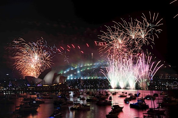 The New Years Eve Midnight fireworks light up the Sydney Harbour Bridge and Opera House.