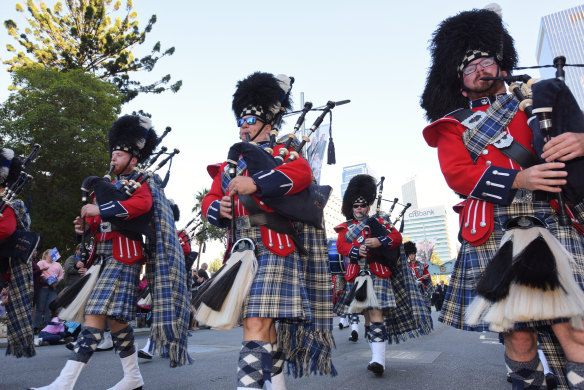 WA Police Pipe Band members play the bagpipe as they parade down St Georges Terrace.