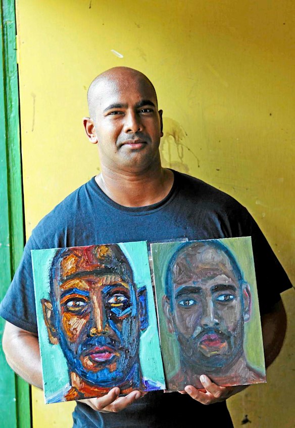 Bali Nine member Myuran Sukumaran poses with two of his portraits after a painting lesson from Ben Quilty in Kerobokan jail.