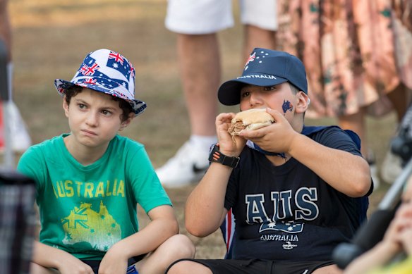 Two boys have a feed as they watch a stage shows during Australia Day festivities at Parramatta Park in Sydney's west.