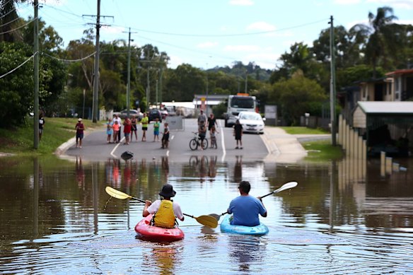 Michael and Caleb Eadie made the most of the flooding at Kokoda Street, Beenleigh.