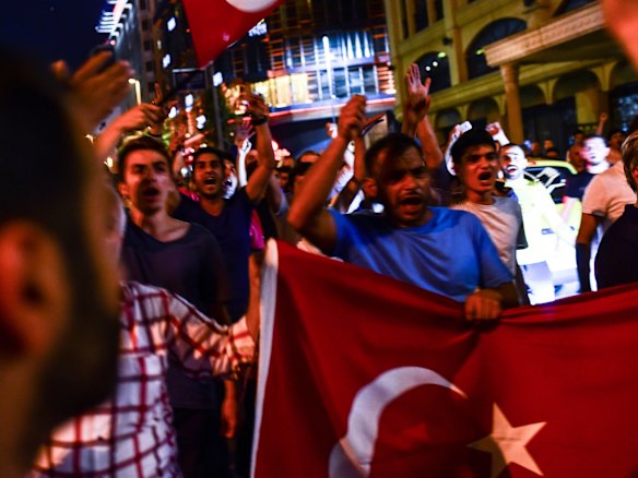 Supporters of Turkish President Recep Tayyip Erdogan march in the main streets of Istanbul in the early morning hours.