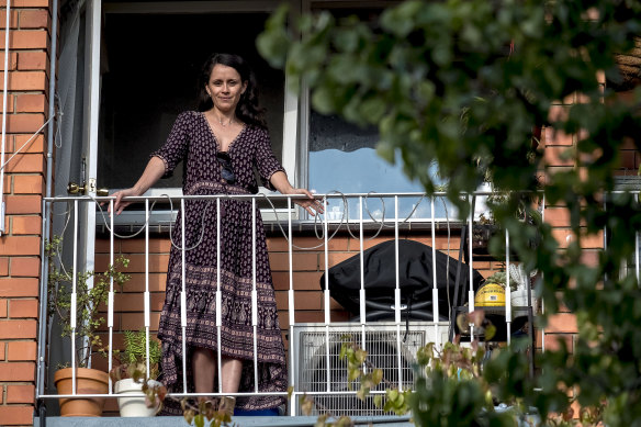 Cassandra Huett stands on her balcony overlooking one of the trees the corellas attacked.