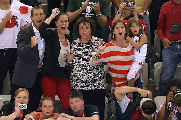 The Phelps family ... mum Debbie (centre), and sisters Hilary (left) and Whitney (right), cheer on Michael Phelps in the men's 200m individual medley final.