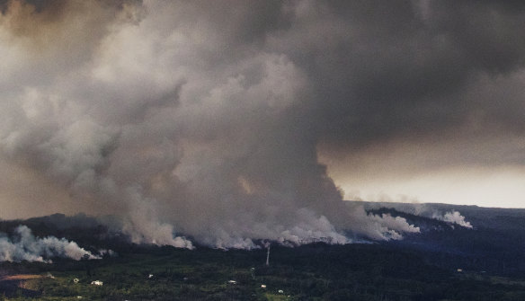 A plume of volcanic steam rises from the alignment of fissures in Hawaii's Kilauea East Rift zone.