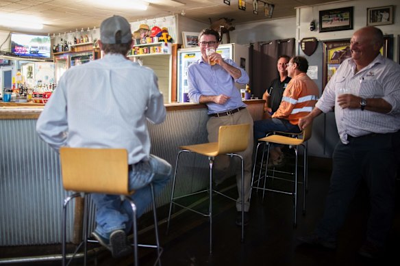 Minister for Agriculture and Water Resources David Littleproud meets with helicopter pilot 'Chook' at the Tambo Tavern, in Tambo, Queensland.