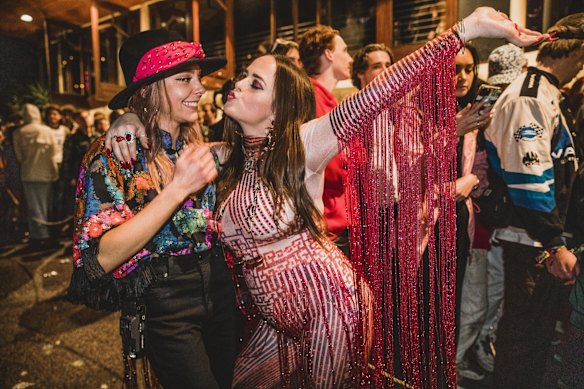 People waited in long queues to enter venues. Dominique Crone and Emily Head, who both travelled from Sydney to attend the festival, waiting in line at The Beach Hotel.