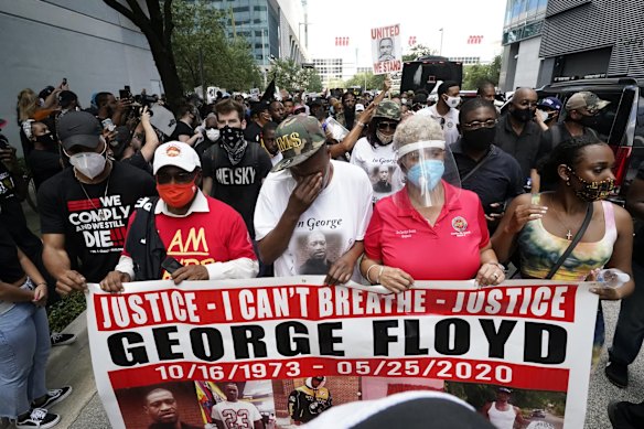 LaTonya Floyd, third from left, participates in a march to protest the death of her brother, George Floyd in Houston on Tuesday.