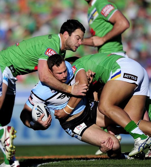 Colin Best is wrapped up by the Raiders' defence.