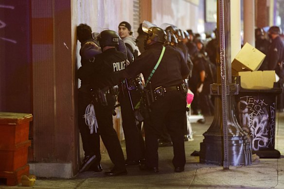 Los Angeles Police Department (LAPD) officers detain demonstrators after declaring an unlawful assembly on election night in Los Angeles, California, U.S.