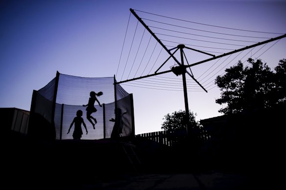 The Ellinghausen sisters bouncing on the trampoline in the backyard as they begin to get used to spending a lot more time at home following stricter restrictions on public gatherings and outdoor activities as a result of the COVID-19 coronavirus pandemic.