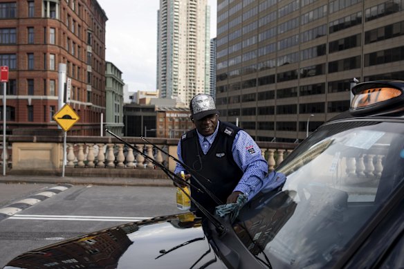Taxi Driver Joshua cleans his taxi outside Central Station. He said business was getting slower due to the outbreak of the coronavirus.