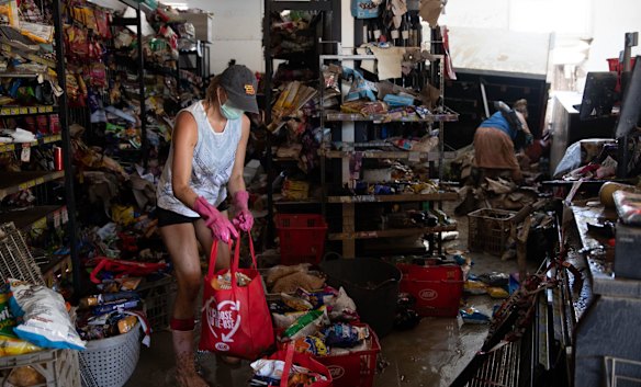Friends, family and community volunteers all help to clean up the damaged shops in Woodburn. 