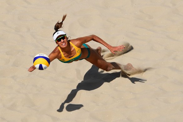 Taliqua Clancy of Australia dives for the ball during the Women's Beach Volleyball preliminary round Pool F match against Natalia Alfaro and Karen Cope Charles of Costa Rica.