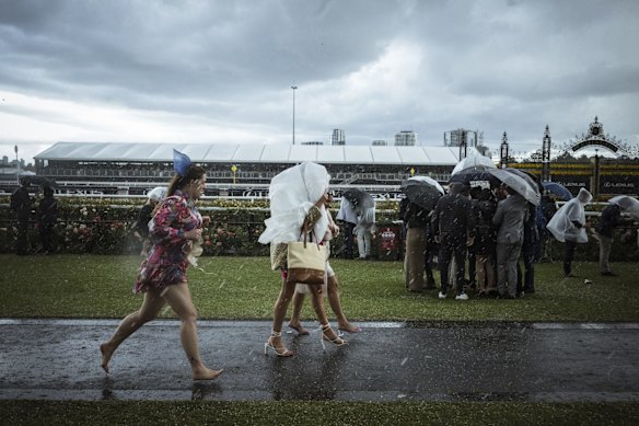 Punters seek shelter from the hail storm.