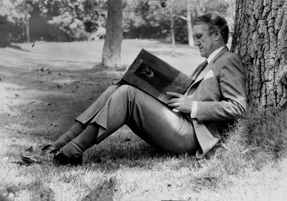 Mr. Fraser, takes time out in the grounds of Vaucluse House yesterday to read A day in The Life of Australia. October 28, 1981