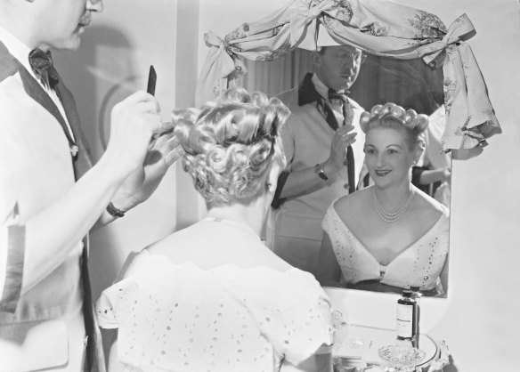 A stylist plants the final touches on a "coronation hairstyle" at a Kings Cross salon in June 1953. 