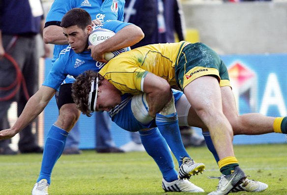 Italy's Edoardo Gori is tackled by Michael Hooper.