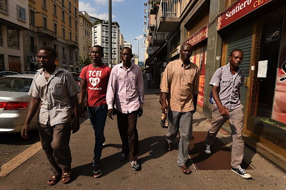 Mohamed Ahmed 23, Adam Abkar Mohamed 20, Mohamed, Haitham Adam 30 and Mohamed Ahmed 23 from Darfur in Sudan walking through the streets of Milan. The men were some of the 415 people rescued by the MY Phoenix.