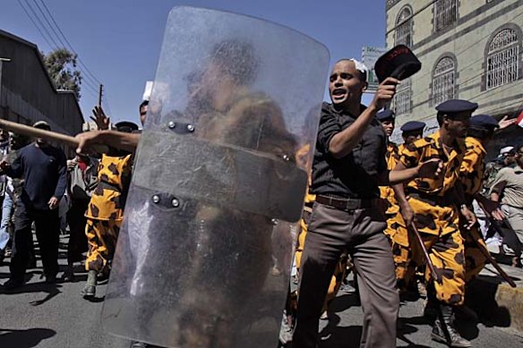 Yemeni riot police charge towards anti-government demonstrators in Sanaa, Yemen.