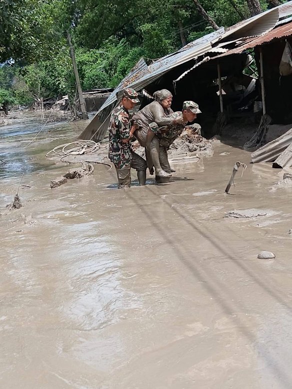 Nepal military service members rescue people from the deadly flash floods.