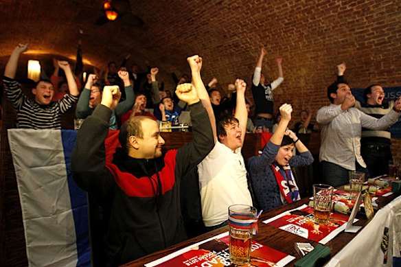 People celebrate at a sports bar in Moscow after the announcement of Russia as the 2018 World Cup host nation.