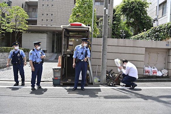 A man pays respect outside Abe's residence in Tokyo.