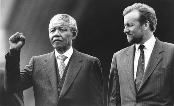 Nelson Mandela raises his fist for the national anthem on the steps of the Sydney Opera House, with Gareth Evans, 1990.