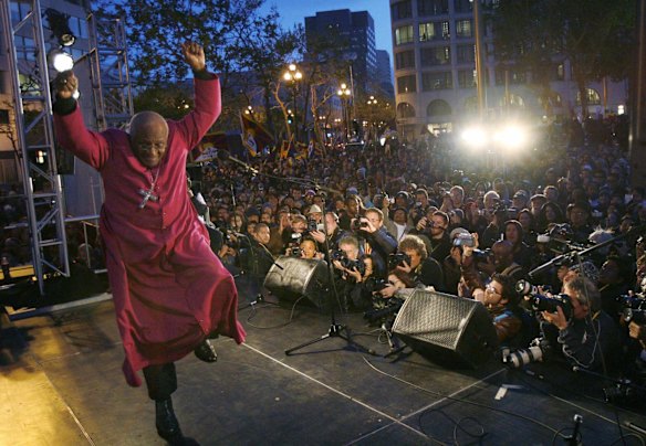 Archbishop Desmond Tutu dances off the stage after speaking at a pro-Tibet rally in San Francisco, California. The Olympic Torch will be run through the streets of San Francisco on Wednesday. 