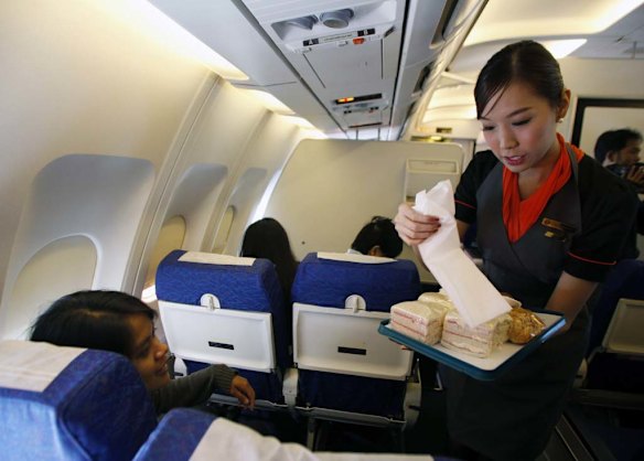 PC Air transsexual flight attendant Chayathisa Nakmai, 24, serves passengers on board the flight.