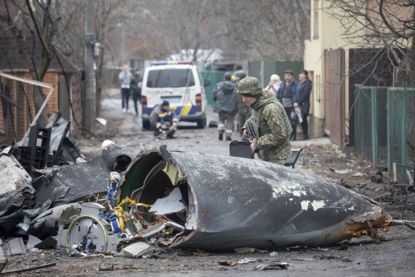 A Ukrainian Army soldier inspects fragments of a downed aircraft in Kyiv, Ukraine, Friday, February 25, 2022.