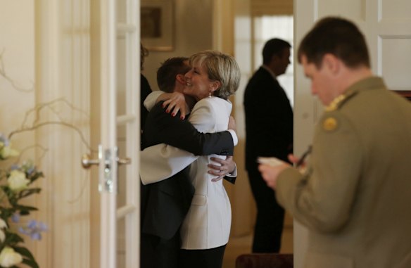 Julie Bishop embraces Wyatt Roy before the ministry swearing in ceremony at Government House in Canberra on Monday 21 September 2015. Photo: Andrew Meares