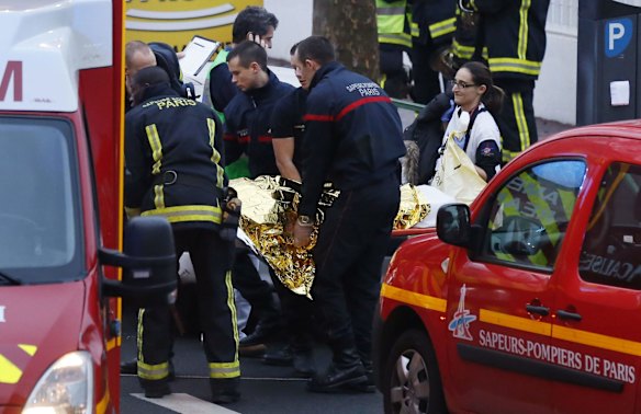 Police, paramedics and firefighters at the scene of the shooting in the south Paris on Thursday, January 8. 