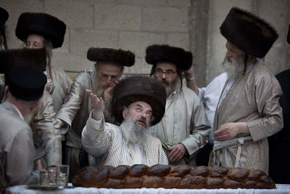 Ultra-Orthodox Jews from the Lelov Hasidic sect gather around their rabbi.