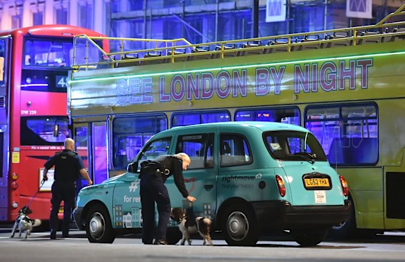 Police sniffer dogs on London Bridge after an incident.