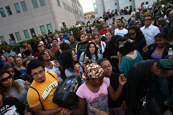 People dance to a Michael Jackson song as they pay their respects to him at UCLA Medical Plaza in Los Angeles, California.