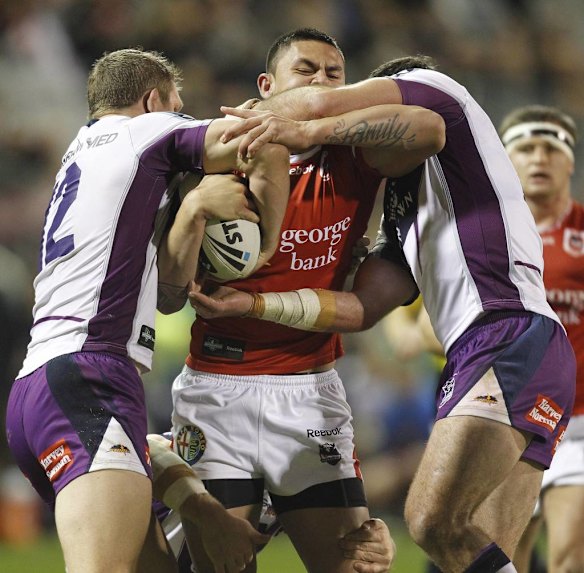 Dragons Daniel Vidot is collared by Storm defenders.