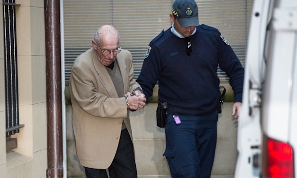 Former NSW Police Detective-Sergeant Roger Rogerson is led from King St Courts after giving evidence in the murder trial of Jamie Gao in May 2016