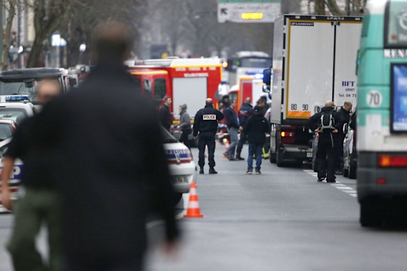 Police, paramedics and firefighters at the scene of the shooting in the south Paris on Thursday, January 8. 