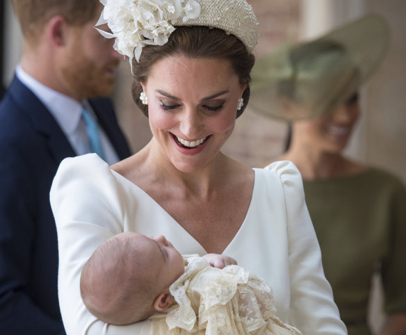 Kate, Duchess of Cambridge carries Prince Louis as they arrive for his christening service at the Chapel Royal in St James' Palace.