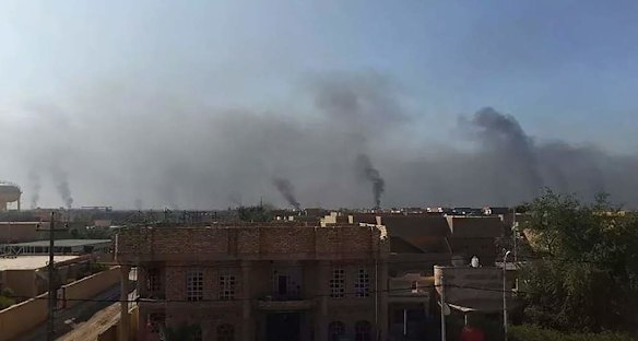 Plumes of smoke rise over Fallujah, a city under the control of the Islamic State, also known as ISIS. Fallujah, Iraq.