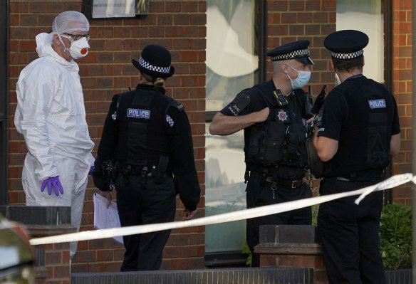 Police officers and forensic examiners at the scene of the attack. 