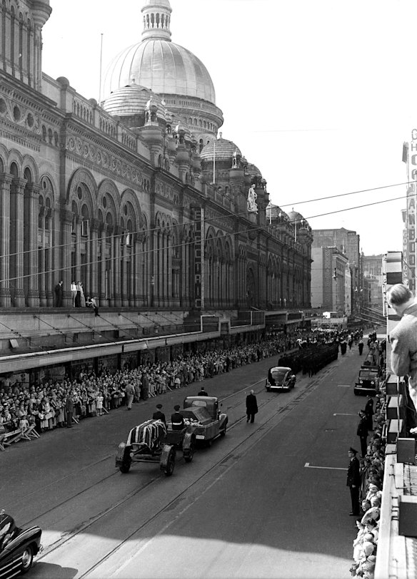 Thousands of mourners line George Street, near the Queen Victoria Building during the procession of the funeral service for former Australian Prime Minister William Morris Hughes at St Andrews Cathedral on 31 October 1952. 