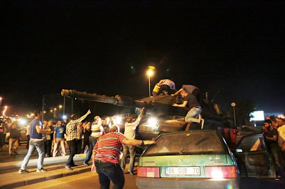 Tanks move into position as Turkish people attempt to stop them, in Ankara, Turkey. Turkey's armed forces said it "fully seized control" of the country Friday and its president responded by calling on Turks to take to the streets in a show of support for the government.